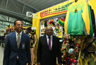 Minister of Tourism, Hon. Edmund Bartlett (right) and Executive Director of the Tourism Enhancement Fund (TEF), Dr. Carey Wallace, tour the facilities at the Norman Manley International Airport (NMIA) in Kingston, during an appreciation activity for the NMIA Team on December 19.

