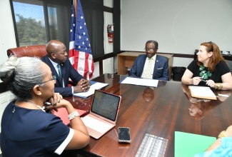 Minister of Labour and Social Security, Hon. Pearnel Charles Jr. (second left), listens to United States Ambassador to Jamaica, His Excellency, Noah Nick Perry (second right), during a meeting at the Ministry’s Heroes Circle offices in downtown Kingston on December 19. The Minister engaged Mr. Perry in discussions surrounding labour and social security matters. Looking on (from left) are Permanent Secretary in the Ministry, Colette Roberts Risden and Consul General, United States Embassy, Ann Marie Chiappetta.

