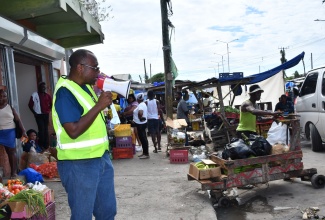 Health Promotion and Education Officer, Westmoreland Health Department, Gerald Miller, addresses residents of Savanna-la-Mar during a dengue fever public education initiative in the town on December 15.

