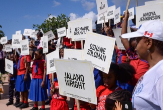St. Catherine students hold signs bearing the names of children who have died due to violence, during an awareness march on December 1 under the theme ‘Protect di Children, Don’t Hurt and Abuse Dem’. A ceremony was also held at the Church of Jesus Christ of Latter Day Saints in Linstead.