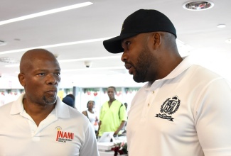 Managing Director, INAMI Management Services Limited, Donovan Betancourt (left), in discussion with entertainer, Jeffery “Agent Sasco” Campbell, during the Digicel Foundation’s recent handover of grants to environmental projects ceremony in downtown Kingston. Through the ‘Good Energy, Clean Environment’ grant campaign, the Digicel Foundation identified and selected 13 projects across 10 parishes that align with its mission to create positive environmental impact.

