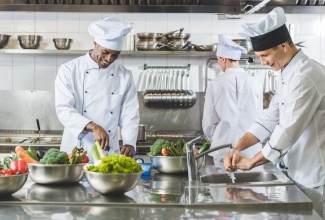 Chefs cooking at restaurant kitchen. 