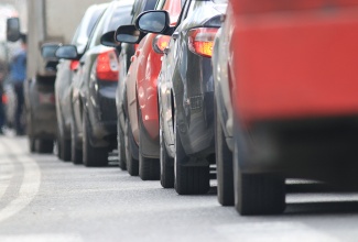 Cars in vehicular traffic. 