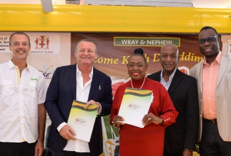 Minister of Culture, Gender, Entertainment and Sport, Hon. Olivia Grange (centre) and Managing Director of J. Wray & Nephew Limited, Jean-Philippe Beyer (second left) display the signed partnership agreement to support Reggae Month, following a ceremony held on Friday (January 26) at the Ministry’s offices, 4-6 Trafalgar Road, Kingston. Also present (from left) are Marketing Director, J. Wray & Nephew, Stefano Furini; Executive Director of the Jamaica Cultural Development Commission, Lenford Salmon and Supernumerary Permanent Secretary, Ministry of Culture, Gender, Entertainment and Sport, Dean-Roy Bernard.

