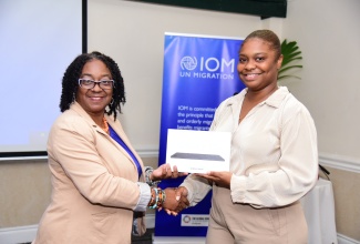 Acting Deputy Director General, Office of Disaster Preparedness and Emergency Management (ODPEM), Michelle Edwards (left), accepts a galaxy tablet from Programme Coordinator, International Organization for Migration, Aaliyah Gentles, during the handover of communication products and equipment (tablets and signage) by the IOM on January 24 at the Courtleigh Hotel and Suites in Kingston. The products were provided under the IOM’s Migrants in Countries in Crisis (MICIC) initiative being implemented under the ‘Strengthening Jamaica’s Disaster Risk Management and Preparedness Capacity’ project. The items are to assist the Government of Jamaica’s preparedness and response efforts, particularly for displaced migrants in emergency events.

