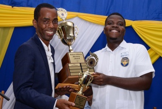 Chairman of CDACC Holding Limited, Rohan Silvera (left), presents the inaugural Rohan Silvera Business Award trophies to top business student at the José Martí Technical High School, Laterell McKenzie, during the recent Founder’s Day Celebrations and Awards ceremony at the St. Catherine-based institution.