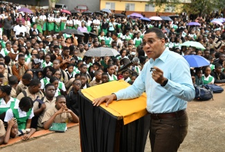 Prime Minister, the Most Hon. Andrew Holness, addressing students at Manchester High School during his recent visit to the Mandeville-based institution.