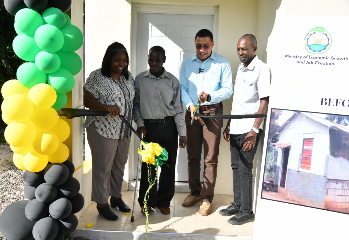 Prime Minister, the Most Hon. Andrew Holness (second right), cuts the ribbon to formally hand over a one-bedroom unit under the New Social Housing Programme (NSHP) to beneficiary, Wellesly McKenzie (second left) of Lacovia in St. Elizabeth on Friday (January 12). Looking on are (from left) Chair, Oversight Committee, NSHP, Judith Robb; and Minister of State in the Ministry of Science, Energy, Telecommunications and Transport and St. Elizabeth North Western Member of Parliament, Hon. William James Charles (J.C.) Hutchinson.