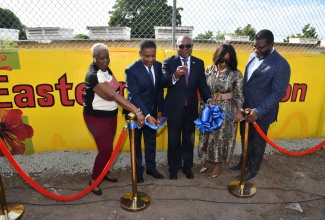 Tourism Minister, Hon. Edmund Bartlett (centre), is assisted by Member of Parliament for East Kingston and Port Royal, Phillip Paulwell (second left), in the ribbon-cutting ceremony for the Eastern Kingston Promenade Programme, on January 15 at 71 Windward Road in Kingston. Also sharing the moment are (from left) Councillor for the Springfield Division, Lorraine Dobson; Chief Executive Officer, Bellevue Hospital, Camille Buchanan; and Executive Director, Tourism Product Development Company Limited (TPDCo), Wade Mars.