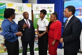Minister of Industry, Investment and Commerce, Senator the Hon. Aubyn Hill (second left), speaks with (from left) Consultant, PriceSmart Foundation, Dr. Bridgette Barrett; Founder/Executive Director, Young Women of Purpose (YWOP)/Young Men of Purpose (YMOP), Lanisia Rhoden; Technical Specialist, Socio-economic Development, Planning Institute of Jamaica (PIOJ), Charmaine Brimm; and Deputy Director General, Corporate Governance and Management, PIOJ, Kirk Phillips. The occasion was Monday’s (January 29) launch of the Realise, Embrace, Achieve Your Purpose (R.E.A.P) Women Entrepreneurship Project 2024 at the PIOJ in New Kingston.