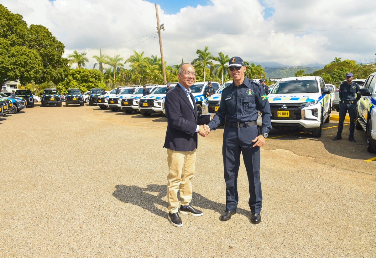 National Security Minister,  Hon. Dr. Horace Chang (left) and Commissioner of Police, Major General Antony Anderson, shake hands during the handover of 30 L-200 pickup trucks on January 19 at the Office of the Commissioner of Police in Kingston. The units, which were handed over by the Ministry of National Security, are valued at more than $230 million.

