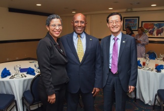 Minister of Industry, Investment and Commerce, Senator the Hon. Aubyn Hill (centre), shares a photo opportunity with (from left) Chief Executive Officer, National Land Agency (NLA) and Commissioner of Lands, Cheriese Walcott; and Chargé d'Affaires, Republic of Korea, Kim Jinwook. The occasion was an NLA/Korean International Cooperation Agency Feasibility Study Partnership Dinner at The Jamaica Pegasus hotel in New Kingston on Monday (January 22).

