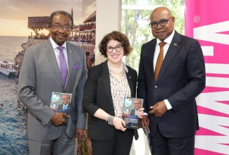 Minister of Tourism, Hon. Edmund Bartlett (right) shares lens time and copies of his new book "Tourism, Resilience and Sustainability in the 21st Century" with the US Department of State's Assistant Secretary for Consular Affairs, Ambassador Rena Bitter (centre) and US Ambassador to Jamaica, His Excellency Nick Perry (left), following a courtesy call by members of a special US delegation yesterday (January 17). 