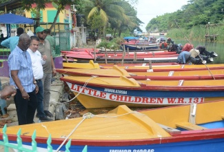 Minister of Local Government and Community Development, Hon. Desmond McKenzie (left), is joined by Minister without Portfolio in the Ministry of Economic Growth & Job Creation, Senator the Hon. Matthew Samuda (second from left), and Ocho Rios Councillor, Michael Belnavis, in touring the White River Fisherman’s Village in St. Ann, on Friday, January 26.

