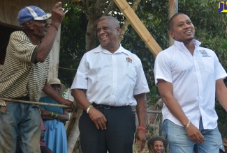 Minister of Agriculture, Fisheries and Mining, Hon. Floyd Green (right), and Minister of State in the Ministry of Agriculture, Fisheries and Mining, Hon. Franklin Witter (centre), interact with farmer Errol Reid during a visit to the Welcome Hall community in South St. James on Thursday, January 17.