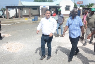 Minister of Local Government and Community Development, Hon. Desmond McKenzie, (right), and Minister without Portfolio in the Ministry of Economic Growth and Job Creation, Senator the Hon. Matthew Samuda, tour the Ocho Rios Transportation Centre in St. Ann on Friday (January 26), to assess the condition of the facility.