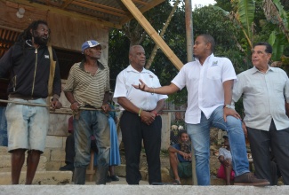 Minister of Agriculture, Fisheries and Mining, Hon. Floyd Green (second from right), converses with farmers Fabian Stennett (left) and Errol Reid (second from left), during a visit to Welcome Hall, St. James, on Thursday, January 17. Looking on are Minister of State in the Ministry of Agriculture, Fisheries and Mining, Hon. Franklin Witter (centre), and Minister of State in the Office of the Prime Minister (West), Hon. Homer Davis.

 