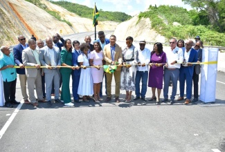 Prime Minister, the Most Hon. Andrew Holness (centre), and wife, the Most Hon. Juliet Holness, who is also Speaker of the House of Representatives, are flanked by several Ministers of Government, representatives of China Harbour Engineering Company (CHEC), agency representatives and other interests during the official opening of the May Pen to Williamsfield leg of the Southern Coastal Highway Improvement Project. The highway was opened on September 14. 