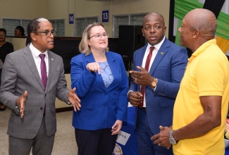 Minister of Labour and Social Security, Hon. Pearnel Charles Jr. (second right), along with (from left) State Minister in the Ministry, Dr. the Hon. Norman Dunn and High Commissioner of Canada to Jamaica, Her Excellency Emina Tudakovic, in conversation with experienced farm worker of over 30 years, Noel Johnson (right), at the send-off of 111 participants in the Seasonal Agricultural Workers Programme (SAWP), during a ceremony held at the Overseas Employment Centre, East Street, Kingston, today (January 3).

 