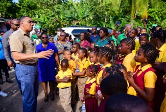 Prime Minister, the Most Hon. Andrew Holness (left), addresses students and teachers of the Jubilee Town Primary School in Berkshire, St. Catherine, on January 18, where he handed over a two-bedroom unit under the New Social Housing Programme (NSHP).