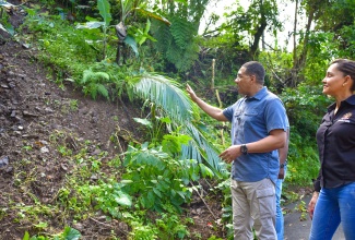 Prime Minister, the Most Hon. Andrew Holness (left), makes a point while on a tour of damaged roads in sections of Portland, on January 5. With the Prime Minister is Member of Parliament for Portland East, Ann-Marie Vaz.

