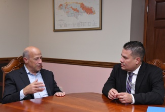 Minister Without Portfolio in the Ministry of Economic Growth and Job Creation, Senator the Hon. Matthew Samuda (right), is briefed on engagements relating to BMR Energy Limited, by President and Chief Executive Officer, Bruce Levy, during a courtesy call at the Ministry’s offices in Kingston on Thursday (January 11).

