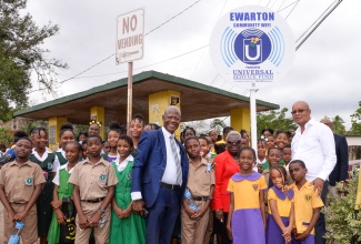 Chief Executive Officer, Universal Service Fund (USF), Daniel Dawes (front centre), is joined by Councillor for the Ewarton Division, Beverly Jobson-Grant (fifth right); Mayor of Spanish Town, Councillor Norman Scott (right); and school children, at the Ewarton community Wi-Fi launch in St. Catherine on January 25.