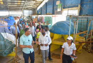 Prime Minister, the Most Hon. Andrew Holness (left), interacts with Deputy Mayor of Montego Bay, Councillor Richard Vernon (second left), during Monday’s (January 8) tour the Charles Gordon Market in Montego Bay, St. James.

