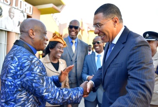 : Prime Minister, the Most Hon. Andrew Holness (right), is greeted by Founder of Power of Faith Ministries International Inc. Miracle Cathedral, Apostle Dr. Delford Davis (left), upon his arrival at Power of Faith Ministries in Portmore, St. Catherine, for the fourth annual National Day of Prayer ‘Heal the Family, Heal the Nation’ service on January 3. Looking on (from second left) are Chair, Jamaica Umbrella Group of Churches and Chair, Jamaica Pentecostal Union, Reverend Dr. Elaine McCarthy; Member of Parliament, St. Catherine South Eastern, Robert Miller and Member of Parliament for St. Catherine East Central, Hon. Alando Terrelonge.