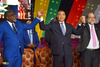 Prime Minister, the Most Hon. Andrew Holness (centre); Leader of the Opposition, Mark Golding (right) and Custos of St. James and Senior Pastor, Faith Temple Assemblies of God, Bishop Conrad Pitkin, hold hands during the fourth annual National Day of Prayer, ‘Heal the Family, Heal the Nation’, at the Power of Faith Ministries International Inc. Miracle Cathedral, Portmore, St. Catherine, on January 3.

