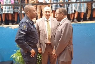 United States Ambassador to Jamaica, His Excellency N. Nickolas Perry (right), speaks  with Country Representative for the United States Agency for International Development (USAID), Dr. Jay Singh (centre) and Acting Assistant Commissioner of Police in charge of Area One, Vernon Ellis, on arrival at the handover ceremony for musical equipment to Flanker Primary School, Montego Bay, St. James, on January 25.

