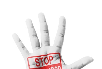 'Stop Child Labour' sign painted in open hand raised. 