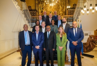 Minister of Tourism, Hon Edmund Bartlett (C-Front) pauses for a photo with Head of Inverotel, Mrs. Encarna Pinero (1st R-Front), other heads of Spanish hotel chains and Senior Tourism officials from the Ministry of Tourism and Jamaica Tourist Board. 