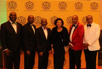 Jamaica’s Ambassador to the United States, Her Excellency Audrey Marks (third right), is surrounded by members of the David “Wagga” Hunt Foundation at the organisation’s 10th annual fundraising gala in Washington DC on February 17. They are (from left) Garth Pottinger, Loxley O’Connor, Lloyd Anderson, Chairman of the Foundation, Christopher Hunt,  and Arnold “Dullo” McDonald.
