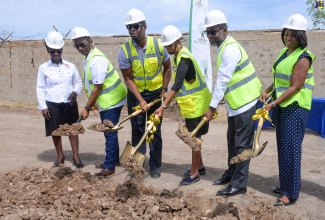 Minister of Education and Youth, Hon. Fayval Williams (third right), breaks ground along with other stakeholders for the expansion of the Bridgeport High School in Portmore, St. Catherine. Others (from left) are Bridgeport High’s Principal, Beverley Harris, and Board Chairman, Dane Levy; Member of Parliament, St. Catherine Southeast, Robert Miller; Mayor of Portmore, Councillor Leon Thomas, and Executive Director, National Education Trust (NET), Latoya Harris-Ghartey.

