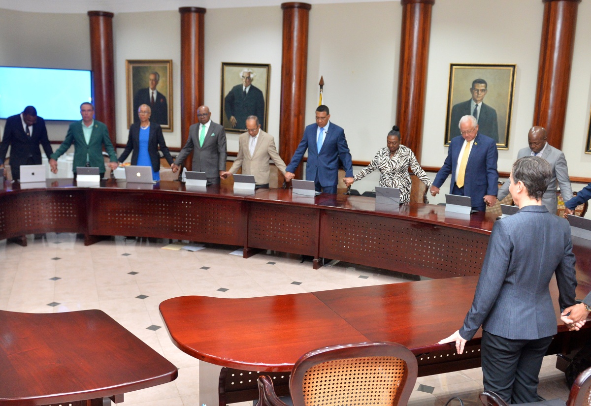 Prime Minister, the Most Hon. Andrew Holness and members of the Cabinet, join hands as they pray with representatives from the Jamaica Umbrella Group of Churches at the Office of the Prime Minister (OPM) on Monday (February 12).
