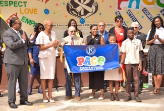 A banner is unveiled for the launch of PACE - Positive Attitudes, Courtesies and Ethics - at Our Lady of the Angels Preparatory School in Kingston on Tuesday (February 6). Celebrating (front row, from left) are Lieutenant Governor for Kiwanis Division 23E, Stephan Rampair; Minister of Education and Youth, Hon. Fayval Williams; Kiwanis Governor for Eastern Canada and the Caribbean, John Chave; Principal, Marcia Meredith; Head Girl, Kaelyn Lawes; Head Boy, Maliq Gibbs, and other participants.

