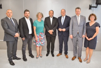President of the Senate, Hon. Thomas Tavares-Finson (centre), shares a photo opportunity with members of a visiting Parliamentary Group from the Bundestag (German Federal Parliament), who paid a courtesy call on him at the Ministry of Foreign Affairs and Foreign Trade in downtown Kingston on Monday (February 12). Visiting are (from left) Parliamentary Group Vice Chairman, Steffen Janich; Vice Chairman and Head of Delegation, Axel Echeverria; Group Member, Susanne Menge; Vice Chairman, Matthias Hauer; Vice Chairman, Jens Beeck, and Assistant to the Group, Monika Hein.