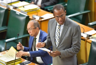 Minister of Finance and the Public Service, Dr. the Hon. Nigel Clarke (right), tables the 2024/25 Estimates of Expenditure in the House of Representatives on February 15. At left is Deputy Prime Minister and Minister of National Security, Hon. Dr. Horace Chang.