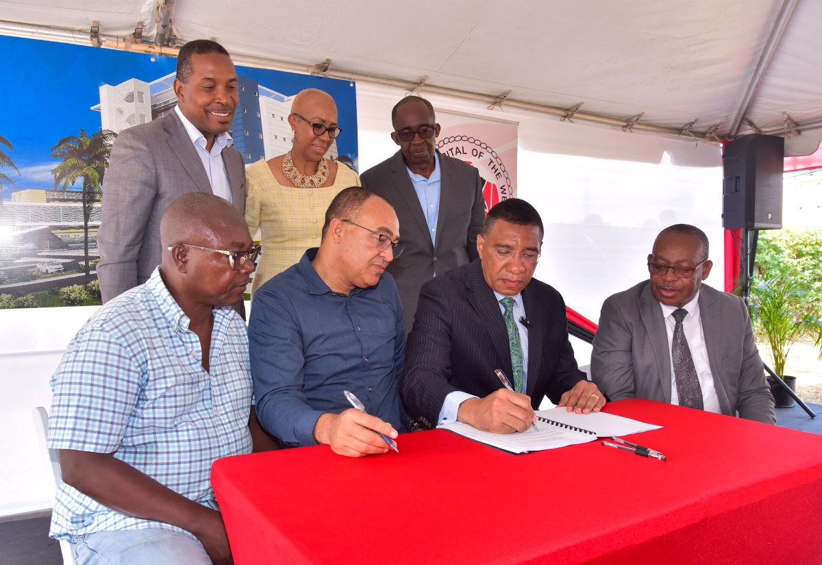 Prime Minister, the Most Hon. Andrew Holness (seated, second right), signs a $278-million contract for phase one of the University Hospital of the West Indies (UHWI) Redevelopment Project at the hospital’s premises in St. Andrew, on February 20. He is joined by (seated from left) Managing Director, Dwight’s Construction, Benton Woodbine; Minister of Health and Wellness, Dr. the Hon. Christopher Tufton; and Acting Chief Executive Officer, UHWI, Fitzgerald Mitchell. In the back row (from left) are Head of Neurosurgery and Medical Chief of Staff, UHWI, Dr. Carl Bruce;  Minister of Education and Youth and Member of Parliament, St. Andrew Eastern, Hon. Fayval Williams; and Chairman, UHWI, Patrick Hylton. During the ceremony ground was also broken for the project.