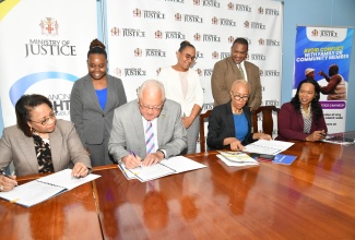 Minister of Education and Youth, Hon. Fayval Williams (seated, second right), and Minister of Justice, Hon. Delroy Chuck (seated, third right), sign a memorandum of understanding (MOU) for the continued delivery of restorative practices training in schools across Jamaica. Observing the signing (seated, from left) are Permanent Secretary in the Ministry of Justice, Grace Ann Stewart McFarlane; and Permanent Secretary in the Ministry of Education and Youth, Dr. Kasan Troupe. Also looking on (standing, from left) are Director of the Restorative Justice Branch in the Ministry of Justice, Joanalee Robertson; Principal Director of the Social Justice Division in the Ministry of Justice, Jamie-Ann Chevannes; and the Education Ministry’s Director for Safety and Security in Schools, Richard Troupe. The signing ceremony was held on Monday (February 5) at the head office of the Ministry of Justice in Kingston.

