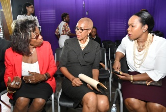 Minister of Education and Youth, Hon. Fayval Williams (centre) shares in a conversation with Chief Executive Officer, Jamaica Teaching Council (JTC), Dr. Winsome Gordon (left) and Permanent Secretary in the Ministry, Dr. Kasan Troupe (right) at the JTC’s Beginning Teachers’ Synergy Conference held at the MICO University College in Kingston on Friday (February 16). 