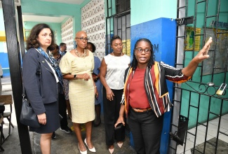 Minister of Education and Youth, Hon. Fayval Williams (second left); Minister of State in the Ministry of National Security, Hon. Juliet Cuthbert-Flynn (second right); and United States Department of State Under Secretary for Civilian Security, Democracy and Human Rights, Uzra Zeya, look on as Principal of Mountain View Primary School, Michelle Robinson (right) points out features of the institution during a tour on Tuesday (February 20).  The visit included the presentation of musical instruments to the school under the ‘Violence Prevention in Targeted Vulnerable Schools and Communities in Jamaica’ programme, which involves partnership between the United States Agency for International Development (USAID) and the Ministry of National Security. Musical instruments valued at approximately $5.3 million have been purchased to equip music programmes as an extracurricular activity in selected schools.