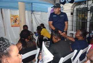 Minister of Health and Wellness, Dr. the Hon. Christopher Tufton, greets persons awaiting their health screenings during the Ministry’s ‘Know Your Numbers’ campaign in Sam Sharpe Square, Montego Bay, St. James, on February 16.

