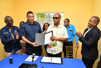 Prime Minister, the Most Hon. Andrew Holness (second left), hands over the New Social Housing Programme contract and keys to beneficiary of the programme, Bertlyn Black (third left) on February 21, at Lancewood in St. Elizabeth. Sharing the moment are (from left) Minister of Local Government and Community Development, Hon. Desmond McKenzie; Councillor for the Brompton Division, Whitney Smith Currie; Mayor of Black River, Councillor Derrick Sangster and Minister of Agriculture, Fisheries and Mining, Hon. Floyd Green.  

