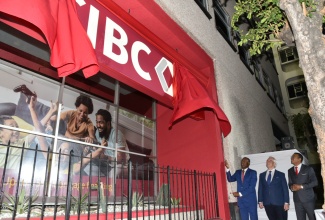 Minister of Finance and the Public Service, Dr. the Hon. Nigel Clarke (left), unveils the new logo for CIBC FirstCaribbean during Wednesday’s (January 31) rebranding launch at the bank’s headquarters on Knutsford Boulevard in New Kingston. Looking on are CIBC Canada’s Executive Vice President for Purpose, Brand and Corporate Affairs, Stephen Forbes (centre), and CIBC FirstCaribbean Managing Director, Nigel Holness.

