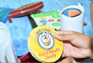 A student from one of the previous training sessions, hosted under the National Environment and Planning Agency’s (NEPA) National Schools Environment Club Programme, displays paraphernalia provided by the entity.

