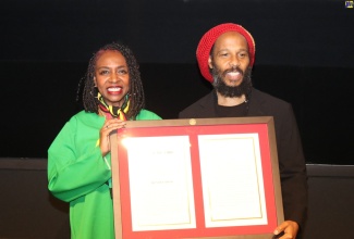 Jamaican-American Congresswoman Yvette Clarke presents Ziggy Marley with a copy of the resolution to recognise the life and legacy of his late father, Robert “Bob” Nesta Marley. The presentation was made at a special screening of  the ‘Bob Marley: One Love’ movie at the Motion Pictures Association in Washington DC on  February 13.