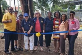 Governor of the Kiwanis Eastern Canada and the Caribbean District, John Chave (fourth left), cuts the ribbon to officially open the equipped playground at the Half-Way Tree Primary School in St. Andrew, recently. Among those sharing the moment are Lieutenant Governor for Kiwanis Division 23 East, Stephan Rampair (left); Faculty Advisor for the school’s Builder’s Club, Sherilyn Clifford (third right); students and other members of the Kiwanis Club.

