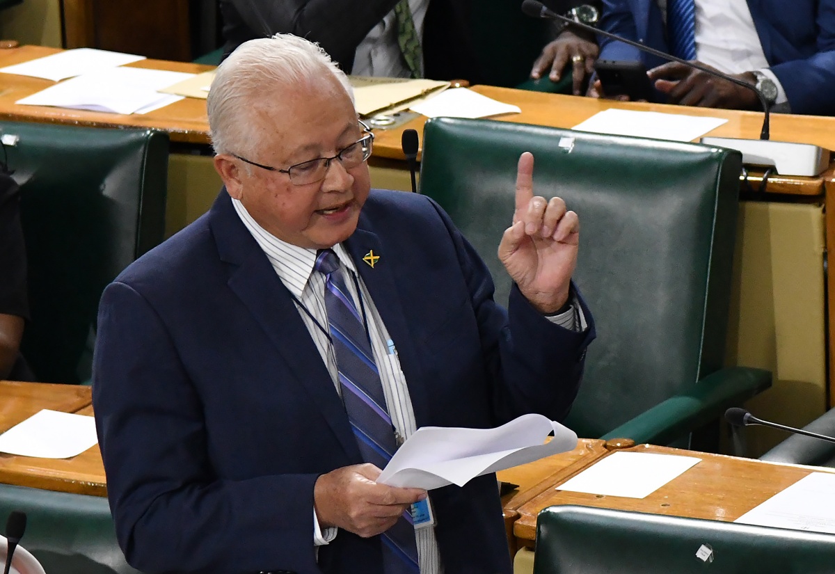 Minister of Justice, Hon. Delroy Chuck, reads from a document in the House of Representatives on February 6.